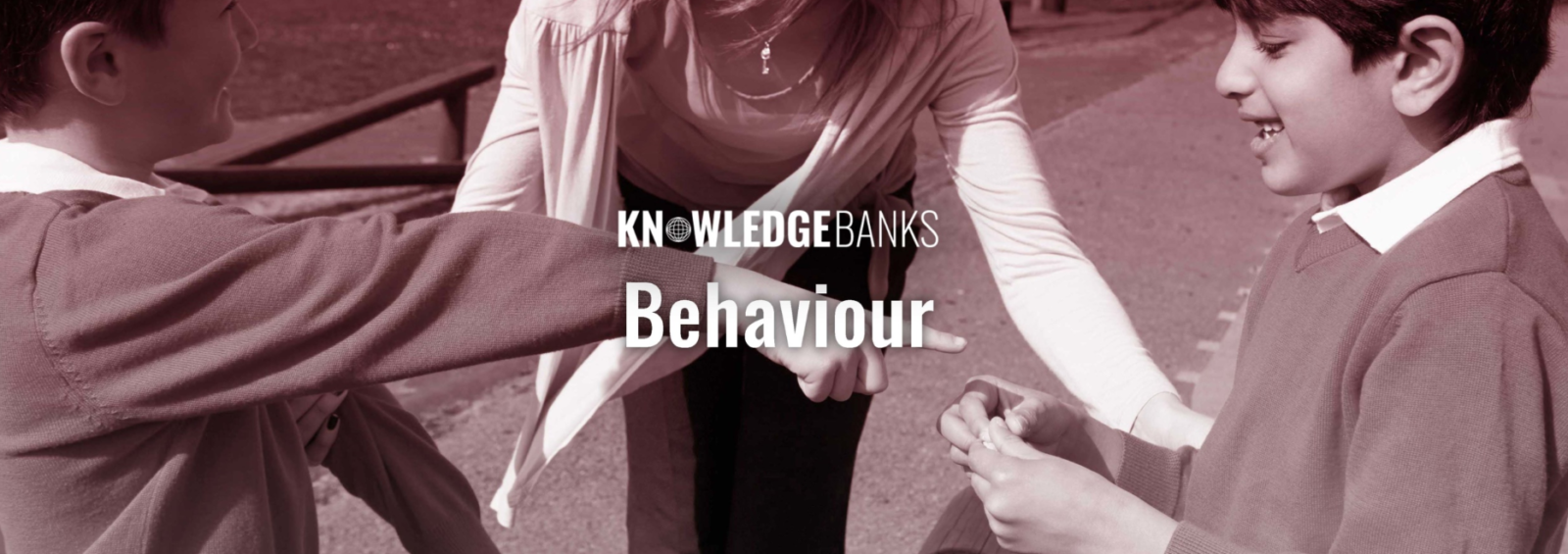 An adult oversees two children in school uniforms exchanging an item on a playground with "Behaviour" text overlay.